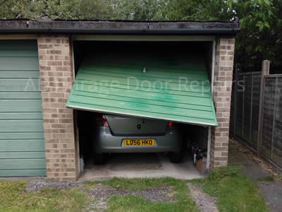 garage door broken with car stuck inside!